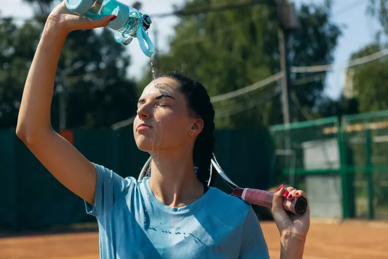 Athlete splashing face with water