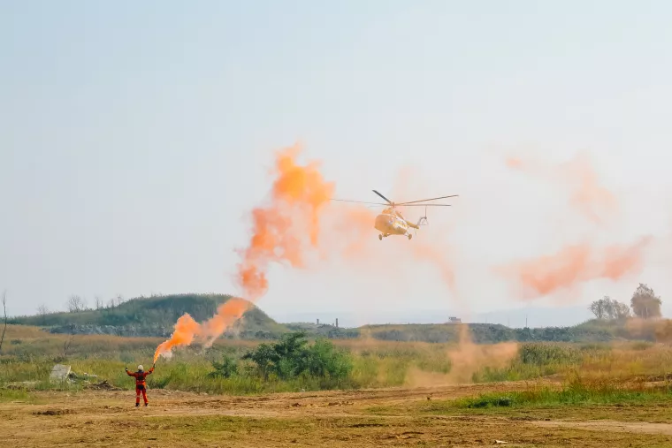 Person sending up a flare for a helicopter